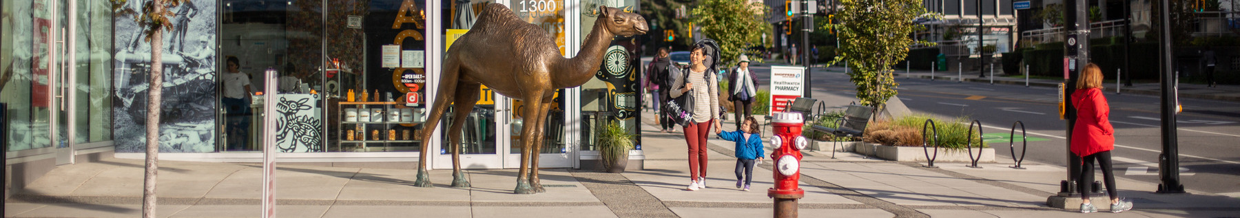 Central Lonsdale Street view with Camel statue and people