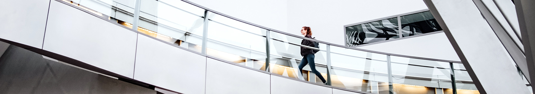person walking on bright airy stairs