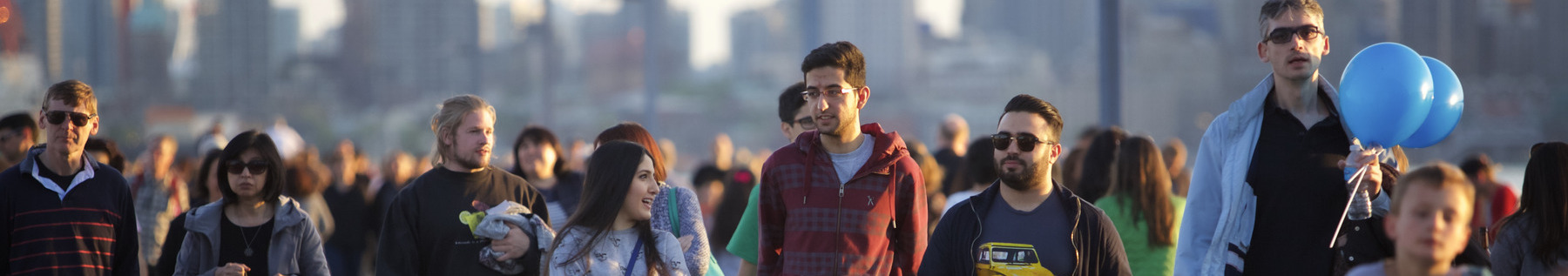 diverse crowd walking along pier