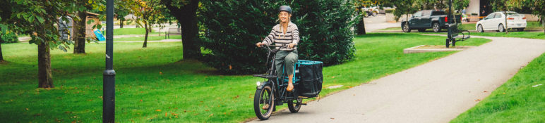 woman riding an e-cargo bike in Victoria Park