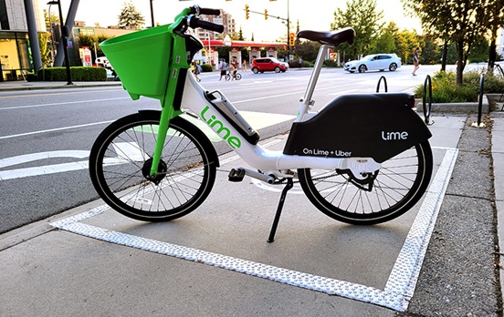 Lime ebikes parked in a grove