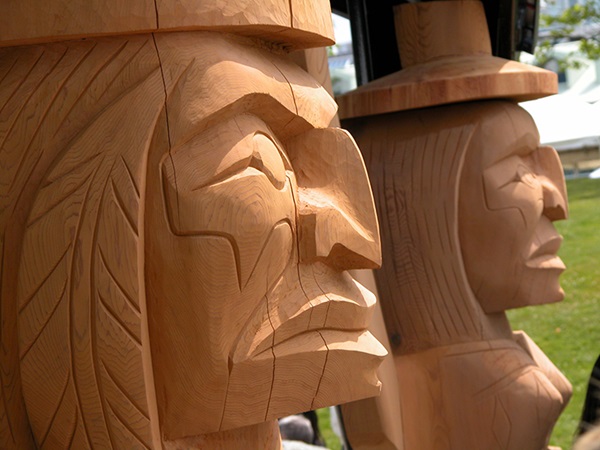 Aboriginal carving of a welcoming grandmother and grandfather by artist Darren Yelton